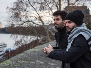 Two young guys with beards looking interestedly at something