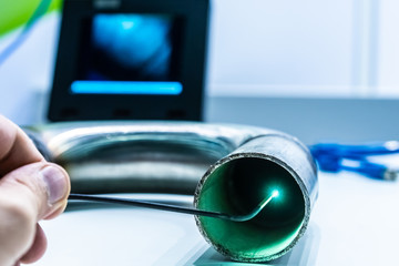 Poster - a man controls a video endoscope. quality control of metal welding. check weld. video endoscope...in