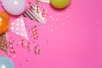 Flat lay composition with balloons and party accessories on color background, space for text