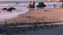 People Enjoying A Local Event Called Circles In The Sand In Bandon, Oregon, United States, Where Artful Patterns Are Drawn In The Sand At Low Tides, And People Walk In Circles.
