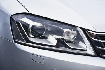 shiny headlight on a  white car