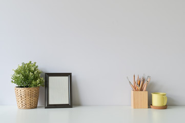 pencil, coffee, photo frame and plant on copy space, office desk.