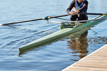 A man in a sports green kayak on the lake