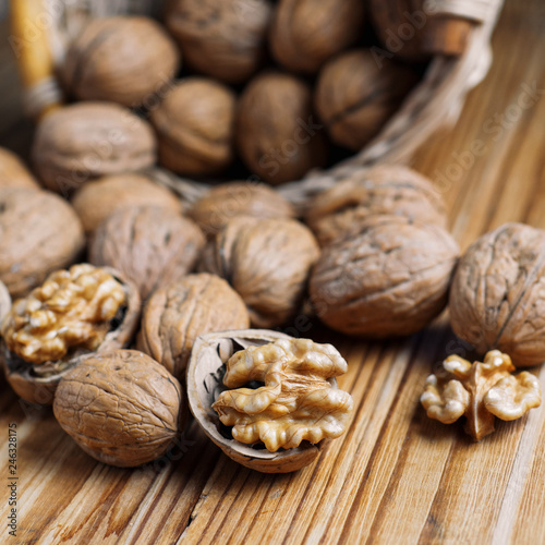 Fotografía Walnut on a wooden table in a wicker basket