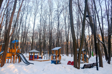 Wall Mural - Palyground aea in the wood during winter under the snow.