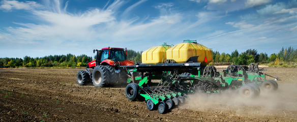 Poster -  Modern, red tractor in the spring field work