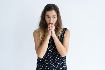 Concerned young woman in dress being worried. Pensive frowning lady with curly hair looking away. Stress concept