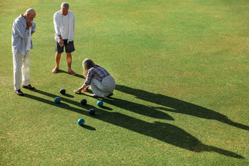 Wall Mural - High angle shot of senior persons playing boules