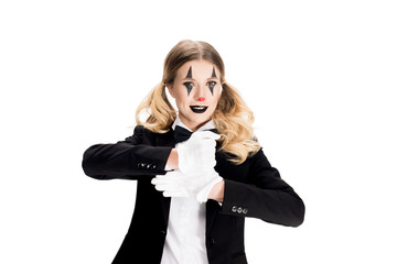 cheerful female clown showing trick in suit isolated on white