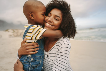 boy enjoying at day out with his mother on the beach