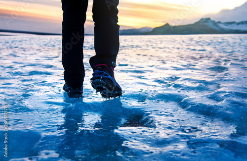 Cuadros en Lienzo Person walking on glacier ice surface wearing crampons