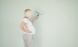 © Анна Бортникова - Photo of a pregnant female painting the wall of a bedroom for her future baby.