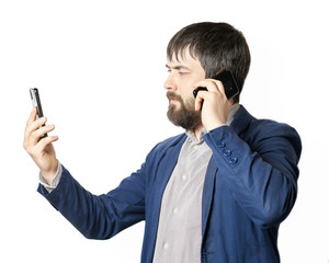 male businessman with a beard looks into the phone