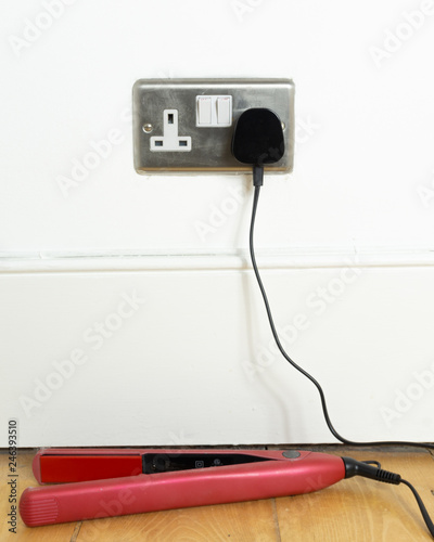 Hair Straightener Left Plugged In And Switched On Safety Concept Stock Photo Adobe Stock