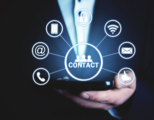 Wall Mural - man holding phone with contact icons.