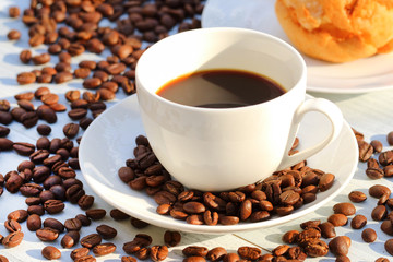 Wall Mural - Coffee cup and coffee beans on the table 