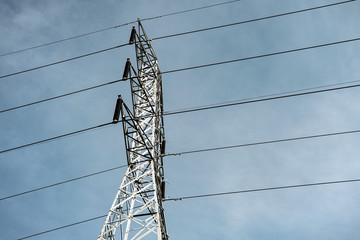 Electricity pole against blue sky clouds, Transmission line of electricity to rural, High voltage electricity pole on bright sky clouds background, electricity transmission pylon