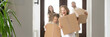 © fizkes - Horizontal photo happy family couple little children hold boxes belongings running into new house buying first home loan and mortgage concept. Banner for website header design with copy space for text
