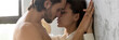 Sensual horny loving teasing couple leaning to wall holding hands kissing having desire sex intimacy passionate date concept. Horizontal photo banner for website header design with copy space for text