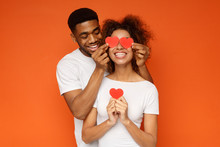 Young Couple Holding Red Love Hearts Over Eyes