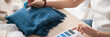 © fizkes - Close up busy fashion designer woman hands hold blue samples swatches make choose check color of textile fabric, dressmaker tailor occupation concept. Horizontal photo banner for website header design