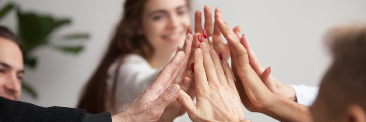horizontal close up photo young business team giving high five celebrate success join hands together