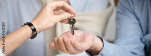 Cuadros en Lienzo Horizontal photo reliable real estate agent giving keys to senior couple, male f