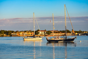 Poster - St. Augustine, Florida. January 26 , 2019 . Sailboats and colorful house's on sunset sky background in Florida's Historic Coast