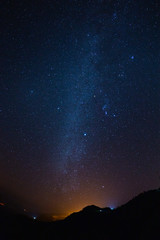 Wall Mural - night sky stars milky way on mountains background