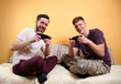 © phoenix021 - young adult man and teen playing games on smartphone, multiplayer game