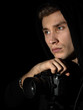 © Валерий Моисеев - Man photographer with a DSLR camera on a tripod in a black hood isolated black background