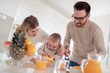 © ivanko80 - Family make fresh orange juice