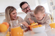 © ivanko80 - Family make fresh orange juice