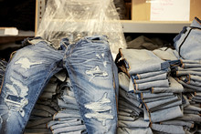 Distressed Jeans On Pile Of Denim Jeans