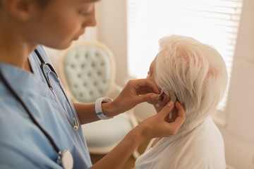 Female physician caring for senior woman