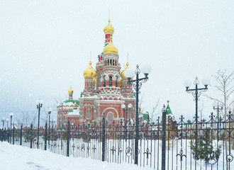 winter urban landscape with snow from buildings and Orthodox Church