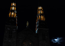 Close Up Of Cathedral Spires At Night Next To The Moon In Winter