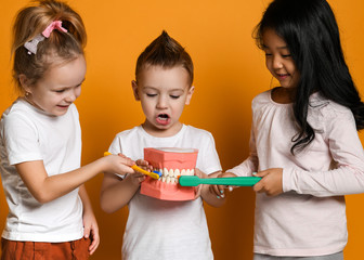 Wall Mural - dental hygiene. happy little cute children with toothbrushes.