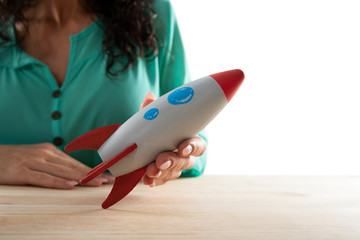 Wall Mural - Businesswoman launches his company with a rocket. Concept of startup and innovation