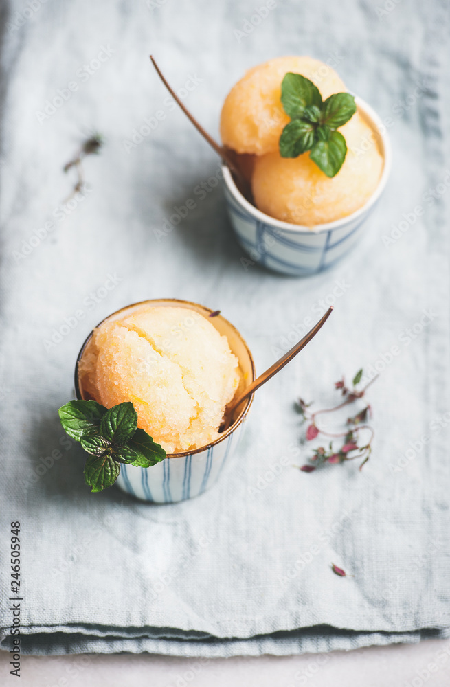 Fresh homemade grapefruit sorbet ice cream scoops in ceramic cups over linen napkin. Healthy vegan summer dessert - obrazy, fototapety, plakaty 