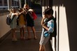 School friends bullying a crying boy in hallway of elementary