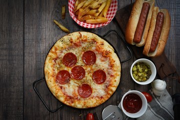 Party game day food Homemade Pizza hot dogs fries and dips ,top view