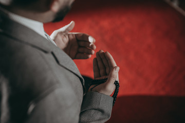 Muslim man praying and reading Quran