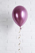 © New Africa - Bright balloon near brick wall. Party time