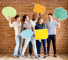 Wall Mural - Diverse happy people holding speech bubble icons