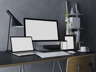 Wall Mural - 3d illustration of mockup design of clean white monitor screen for web preview on modern workplace indoor with desktop, tab, laptop, and phone on stylish black desk and grey wall in three quarter view