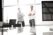 © ASDF - business background.two employees standing in a modern office.