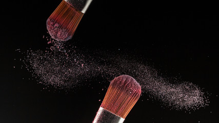 Poster - Close up powder splash and brush for makeup artist or beauty blogger in black background