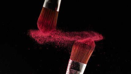 Poster - Close up powder splash and brush for makeup artist or beauty blogger in black background