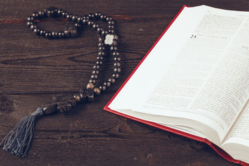 Sticker - Bible and a crucifix on an old wooden table. Religion concept.